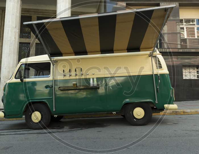Isolated Food Truck Of Beer Taps In A Vintage Green And Beige Van