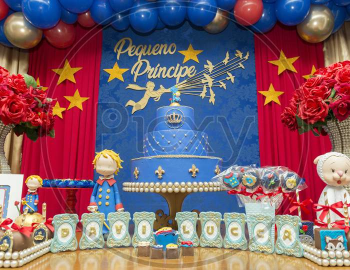 Kids Birthday Party Decoration. Blue Fake Cake With Candle. Little Prince Theme Party. Decorated Table For Child Birthday Celebration. Close Up Of Decor Party.