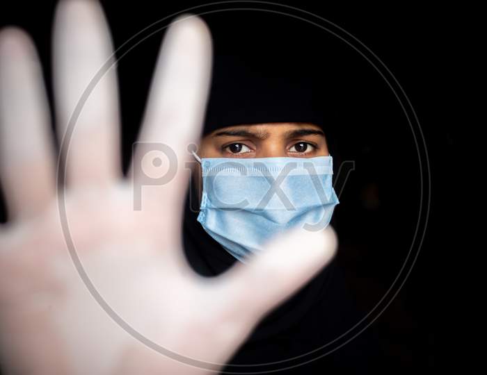 Stop Coronavirus. A Young Asian Woman Wearing A Face Mask And Medical Rubber Gloves. Protest And Focus Shifted Photo.
