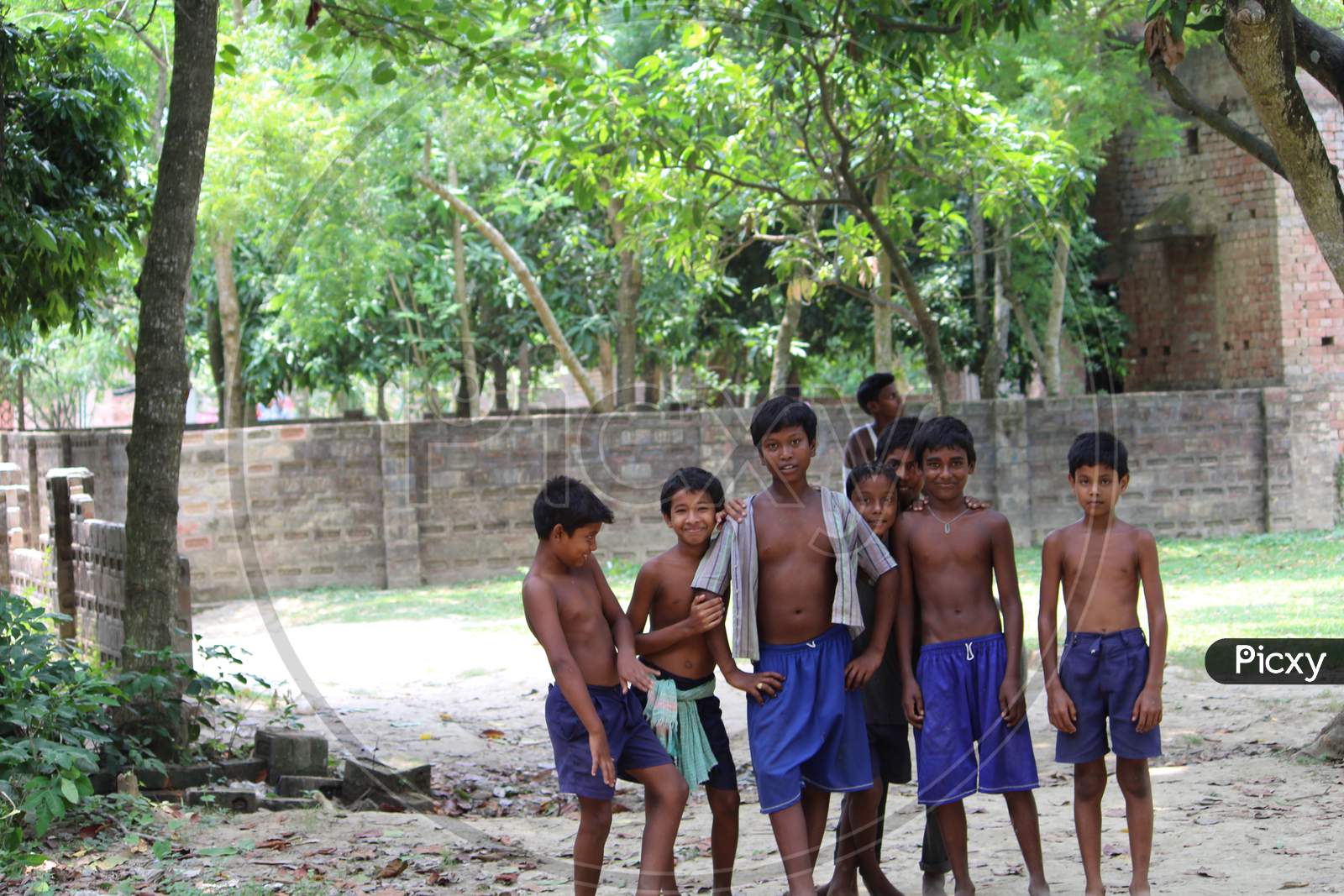 a group of boys happy to give a pose in a rural village