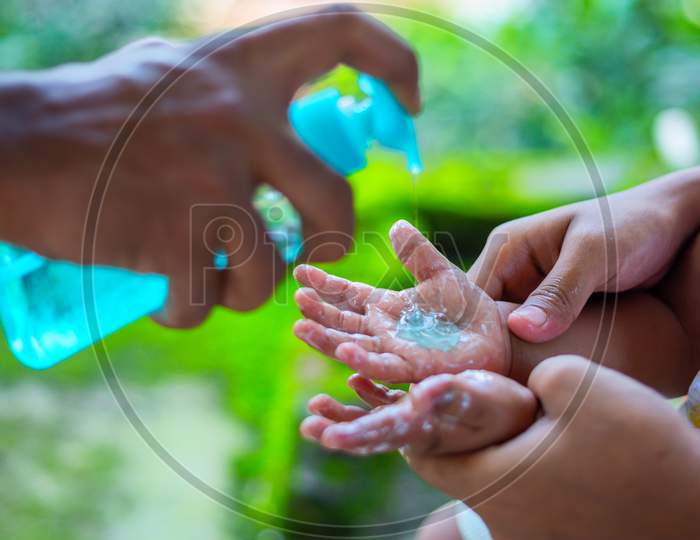 A Parent Teaching His Baby The Habit Of Handwashing With Liquid Hand Wash. To Prevent Coronavirus, Rubbing Your Hands With Soap Is An Expert Way To Stop The Spread Of Coronavirus.