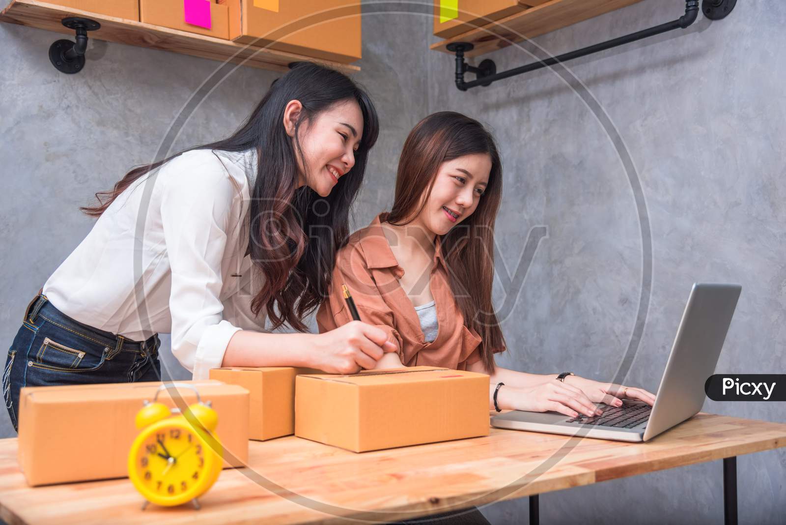 Two Young Asian People Startup Small Business Entrepreneur Sme Distribution Warehouse With Parcel Mail Box. Small  Owner Home Office. Online Marketing And Product Packaging And Delivery Service