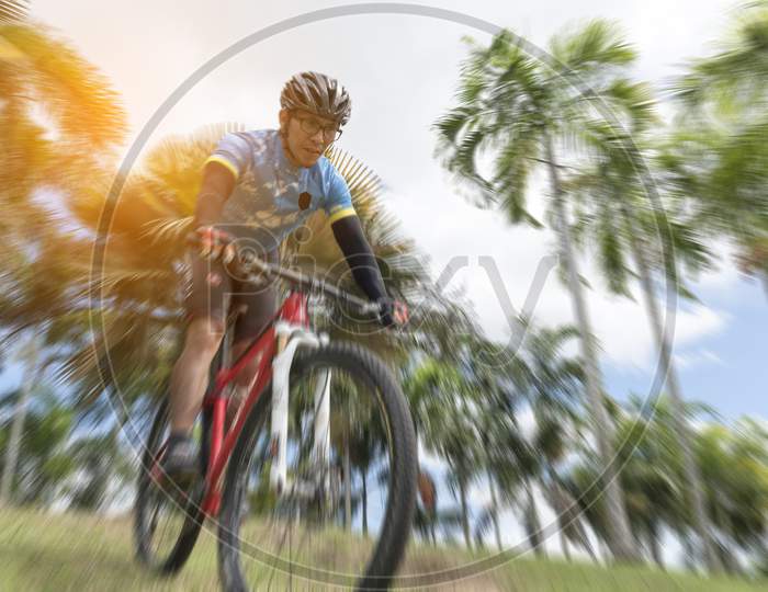 Sportsman Cycling The Bicycle From Highland, Selective Focus, Radial Blur, Sport Concept