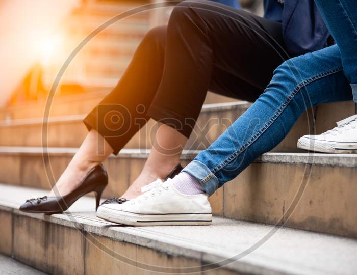 Close Up Of Two Woman Legs. Friend Are Talking Together On Stair. People And Lifestyles Concept. Social And Conversation Concept. Friendship Theme.