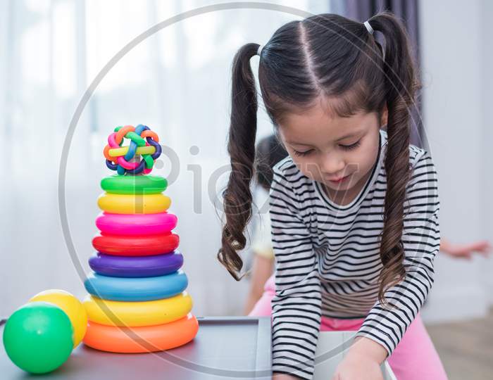 Little Girls Playing Small Toy Hoops In Home. Education And Happiness Lifestyle Concept. Funny Learning And Children Development Theme. Smile Faces