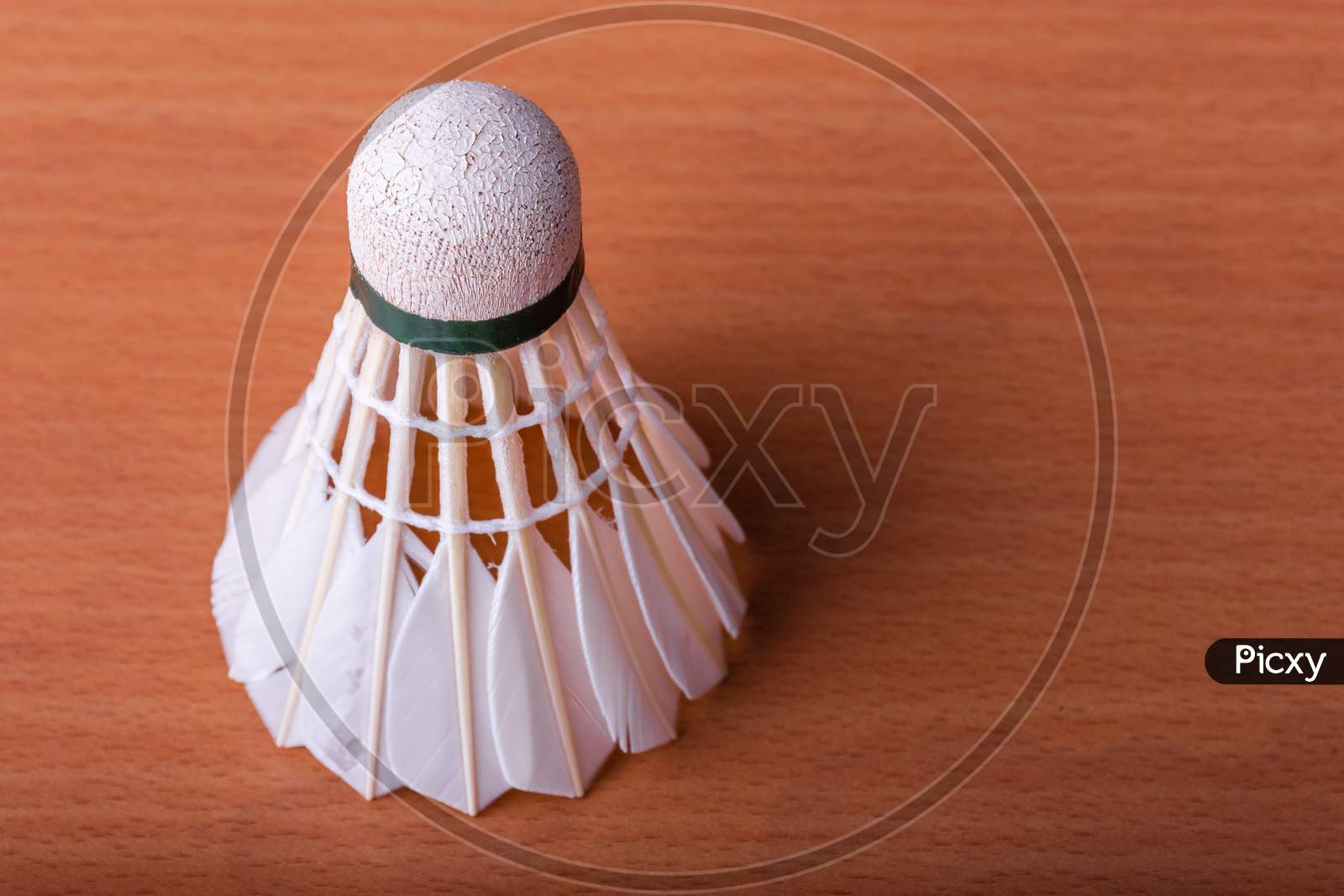 Badminton Shuttlecock On Wooden Table. Sport And Athlete Concept.