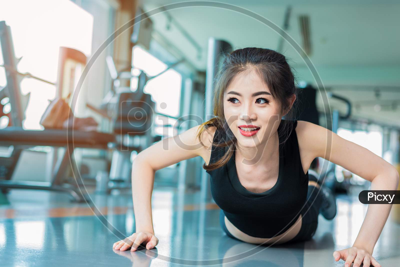 Asian Woman Fitness Girl Do Pushing Ups At Fitness Gym. Healthcare And Healthy Concept. Training And Body Build Up Theme. Strength And Beauty Concept