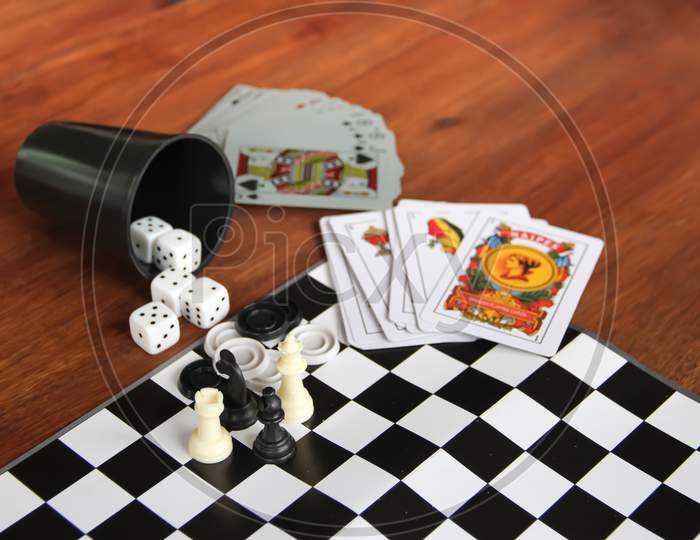 Mix Of Goblet Table Games Dice Spanish Poker Cards Chess And Checkers