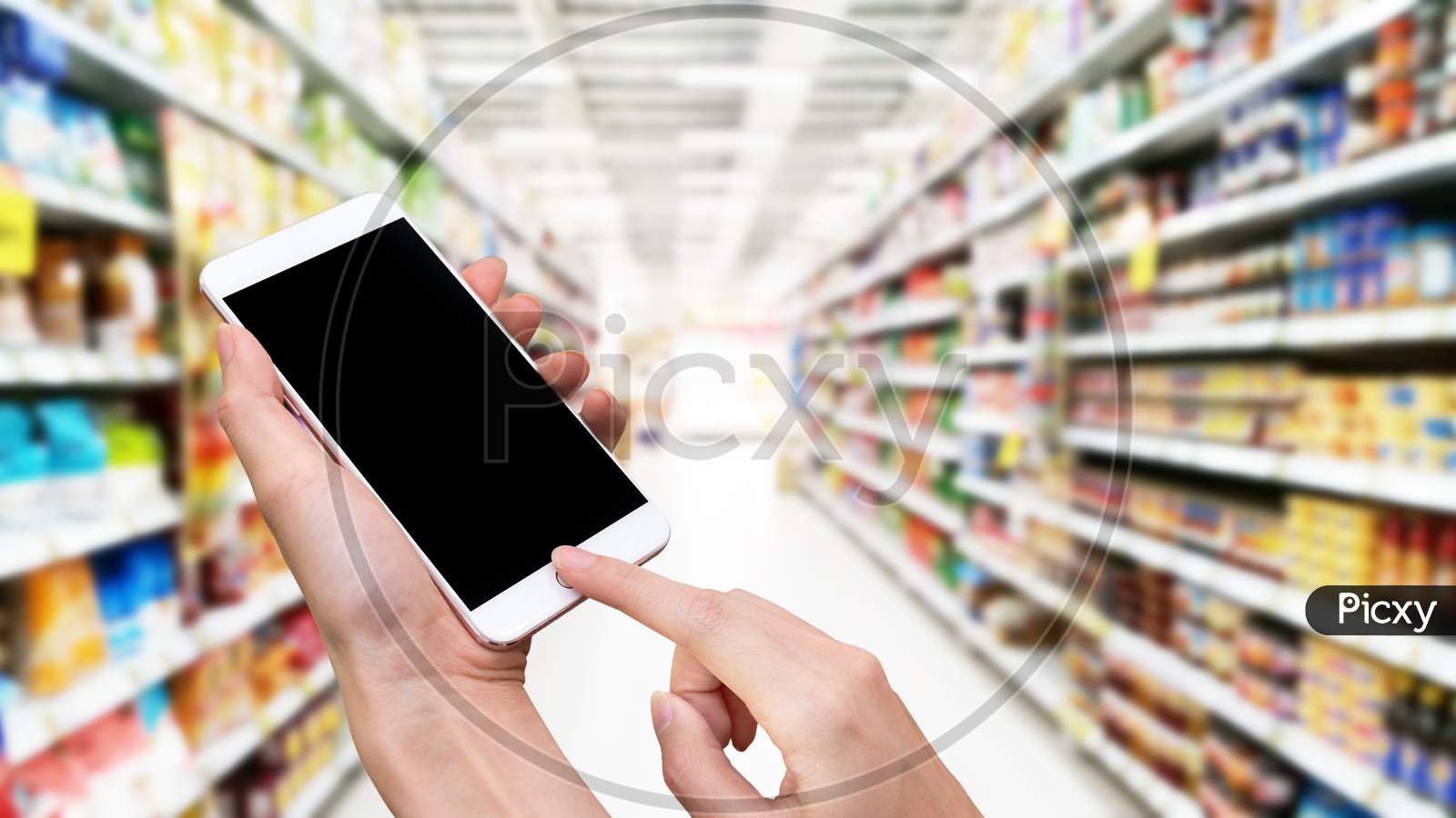 Woman Hold Smart Phone And Touch Button By Hand With Blank Screen For Advertisement, Blurry Supermarket Background ,Technology And Online Shopping Concept