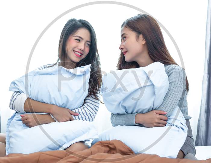 Two Asian Lesbian Looking Together In Bedroom.Beauty Concept. Happy Lifestyles And Home Sweet Home Theme. Cushion Pillow Element And Window Background.