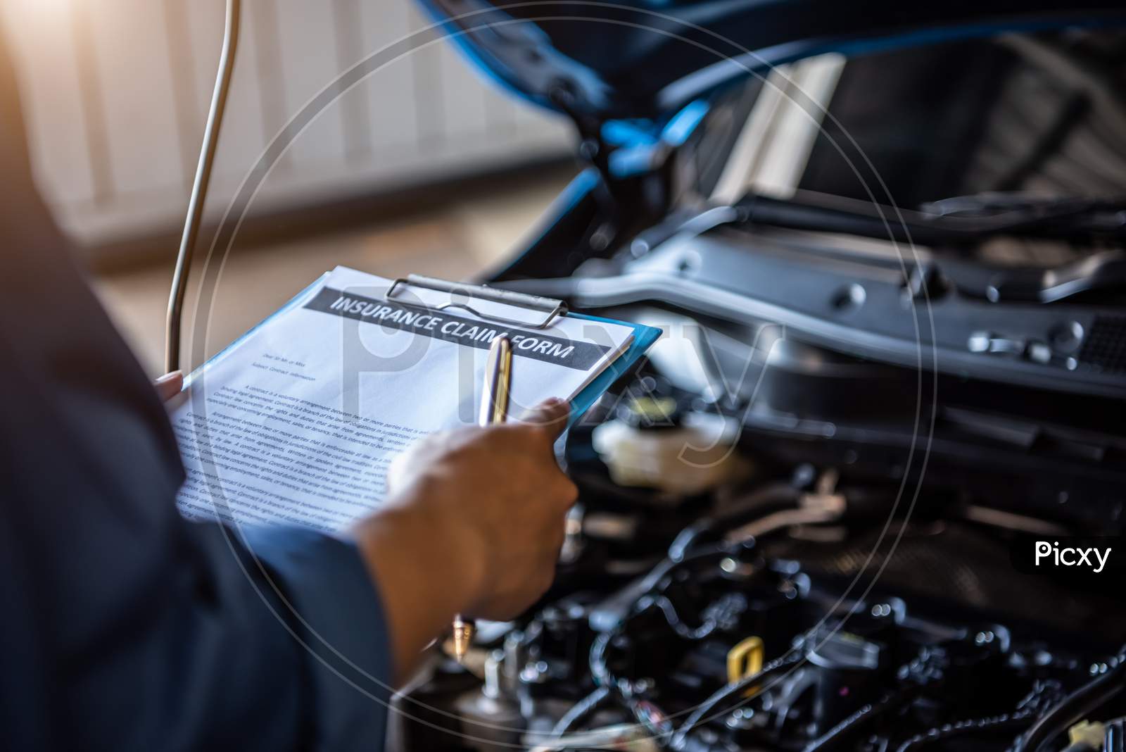 Car Mechanic Holding Clipboard And Checking To Maintenance Vehicle By Customer Insurance Claim Order In Auto Repair Shop Garage. Engine Repair Service. People Occupation And Business Job. Technician