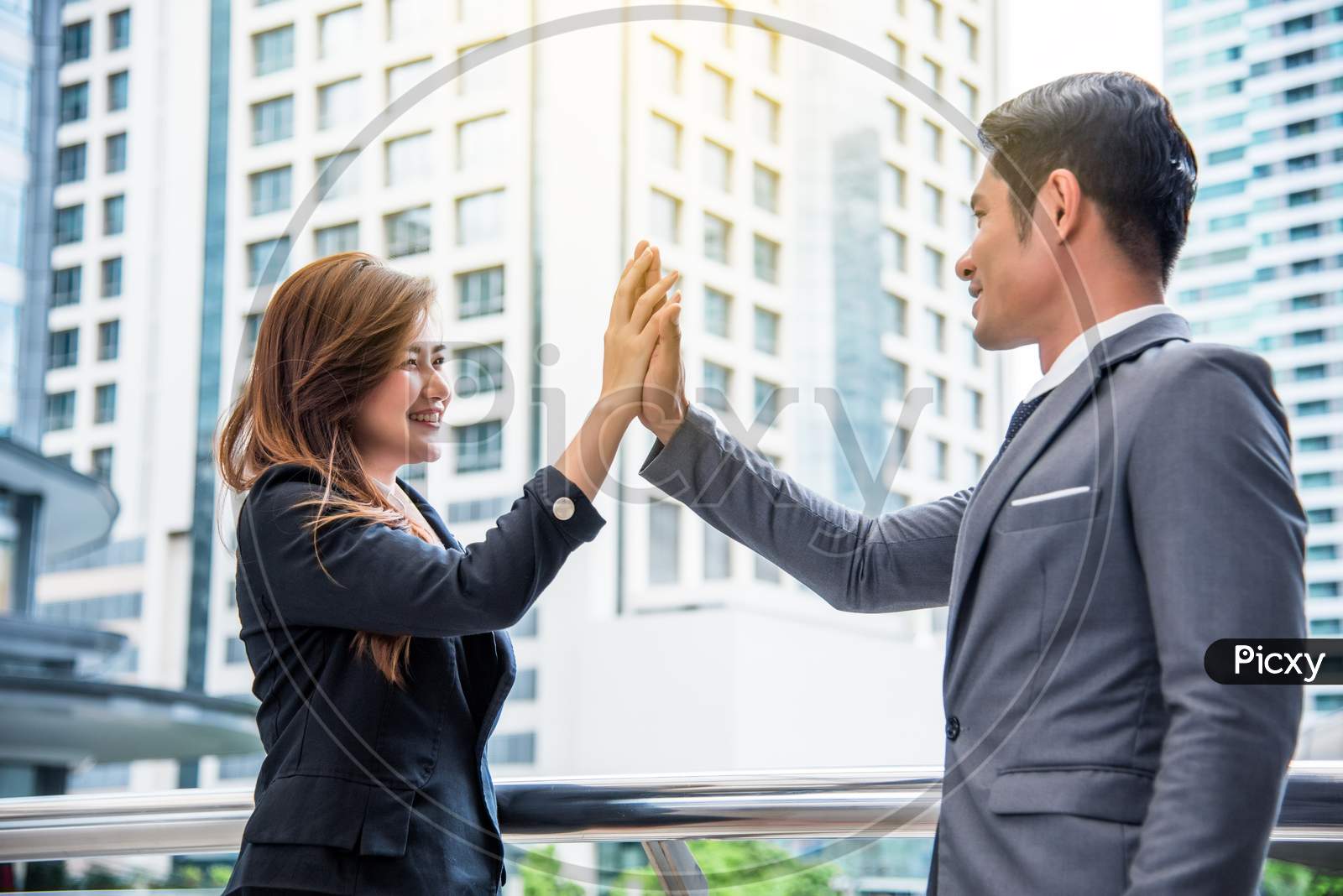 Businessman And Business Woman Doing High Five, Business Concept, Successful Concept, Cooperation Concept