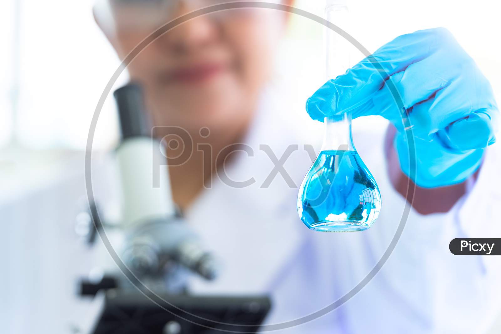 Female Scientist Hold And Showing Laboratory Test Tubes And Solution With Stethoscope. Science And Medical Background. Scientist Research And Analysis Biotechnology Concept. Selective Focus Blue Flask