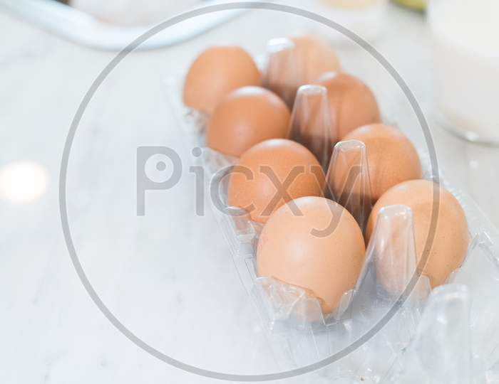 Close Up Of Dozen Of Eggs On White Table For Prepare Cooking In Kitchen. Dessert Ingredients And Food Concept.