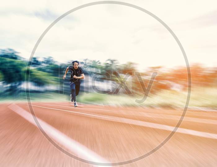 Running Man Running On The Track With Radial Blur, Sport And Activity Concept
