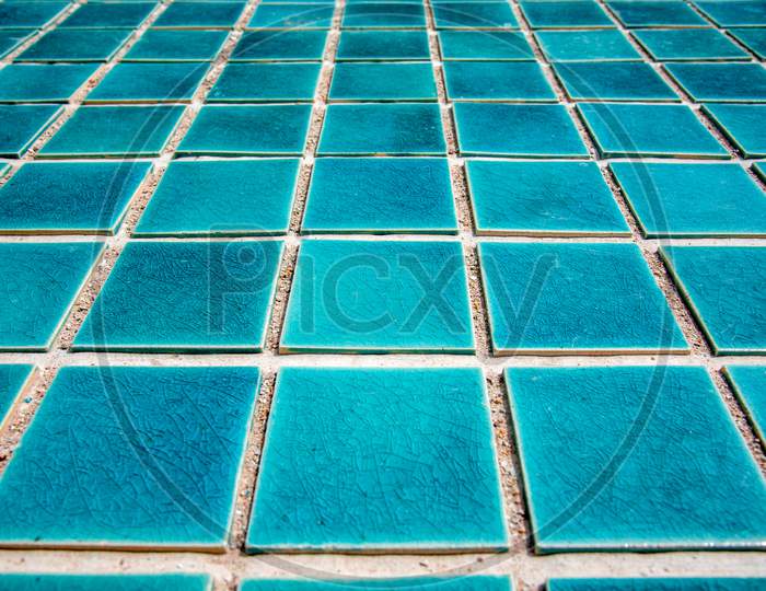 Close Up Of Blue Swimming Pool Tiled Floor. Architect And Construction Concept. Material And Design Concept. Interior And Exterior Theme. Perspective View Angle.