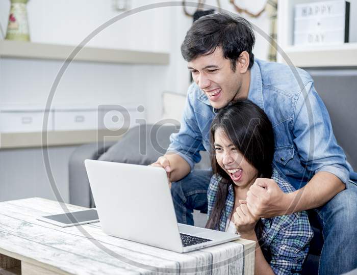 Lover Are Surprising When Using The Laptop. Family Concept, Lovers Concept, Technology Concept