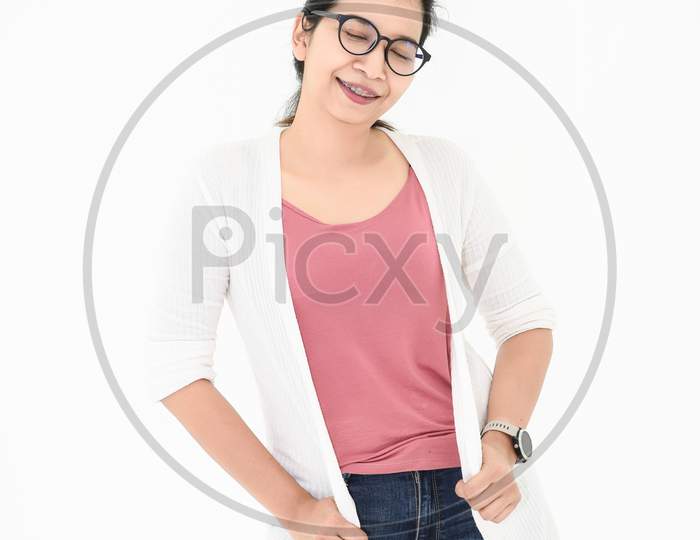 Asian Woman Posing With Casual Outfit And Eyeglasses In Happy Mood On White Isolated Background. Closed Eyes Fashion Acting. People Beauty And Portrait Concept.