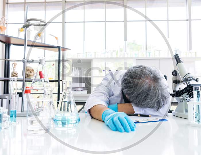Exhausted Scientist Sleeping In Laboratory. People Lifestyles And Occupation Concept. Science And Experiment In Lab Theme.