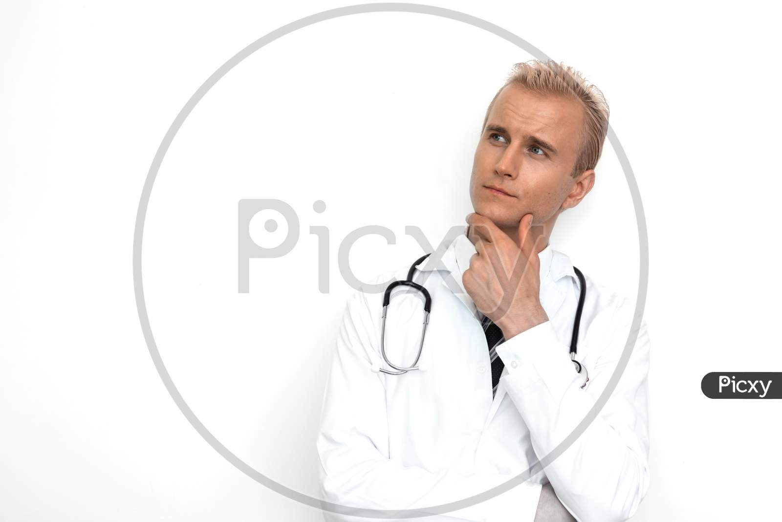 Doctor With Stethoscope Thinking And Imagine On The White Background. Medical And Healthcare Concept. Hospital Theme