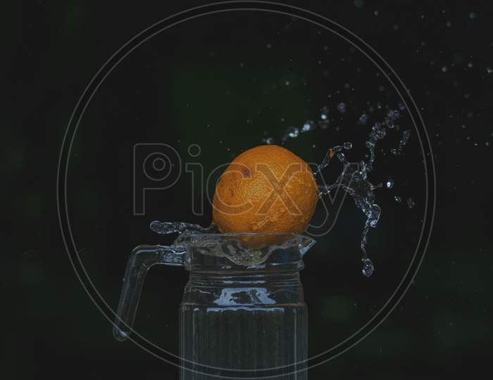 Water splash photography with Orange fruit.