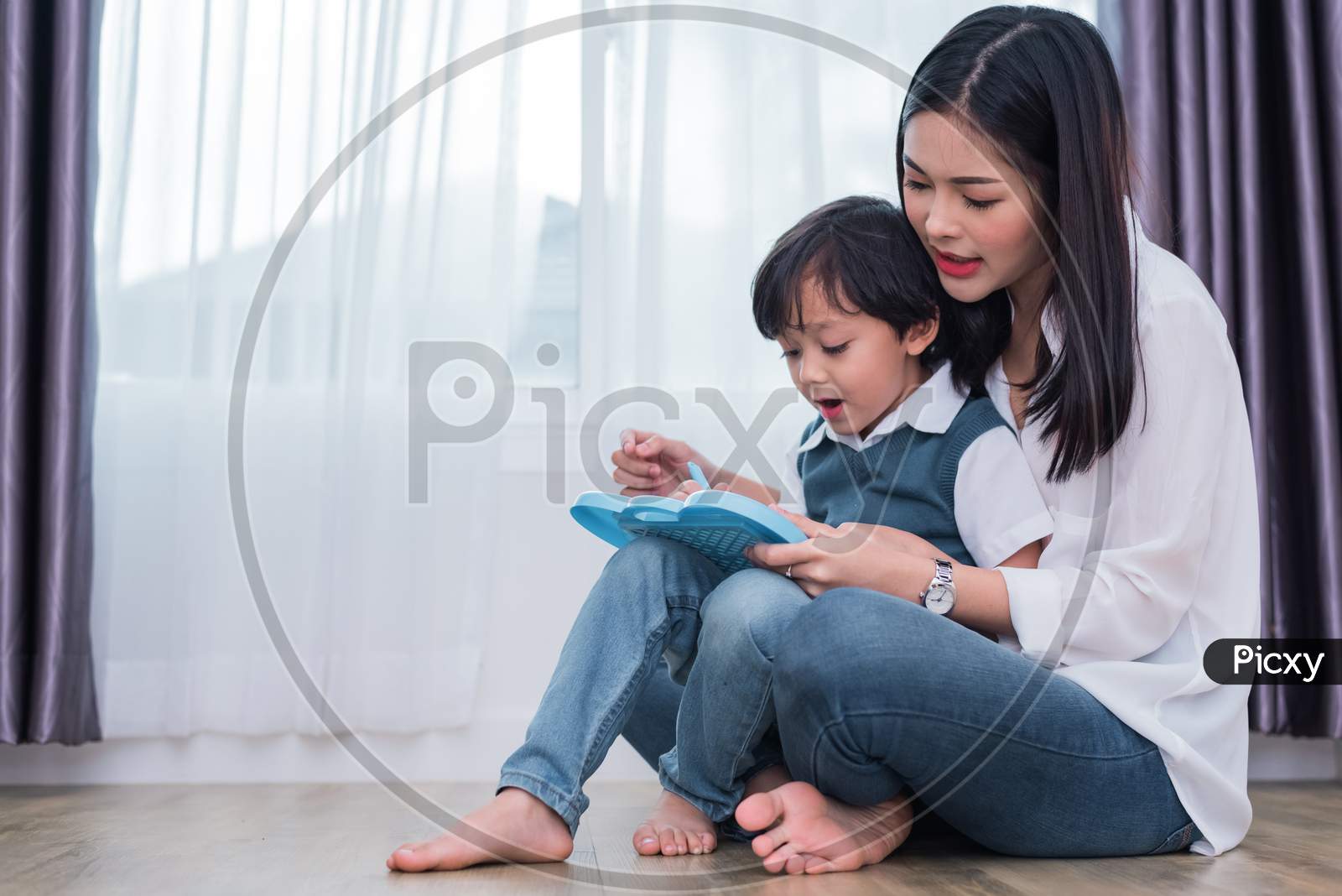 Asian Mom Teaching Cute Boy To Drawing In Chalkboard Together. Back To School And Education Concept. Family And Home Sweet Home Theme. Preschool Kids Theme.
