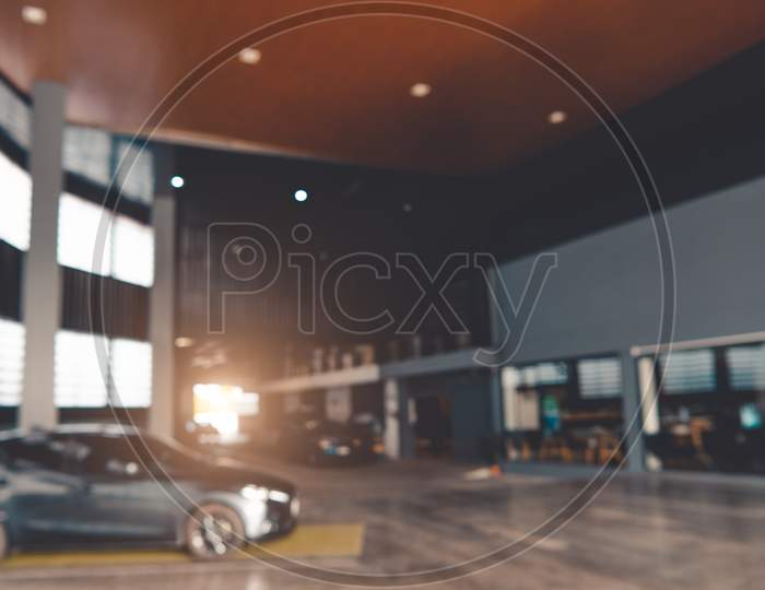 Blurred Background Of Car Showroom Garage. Automotive Car And Business Transportation Concept. Abstract Background.