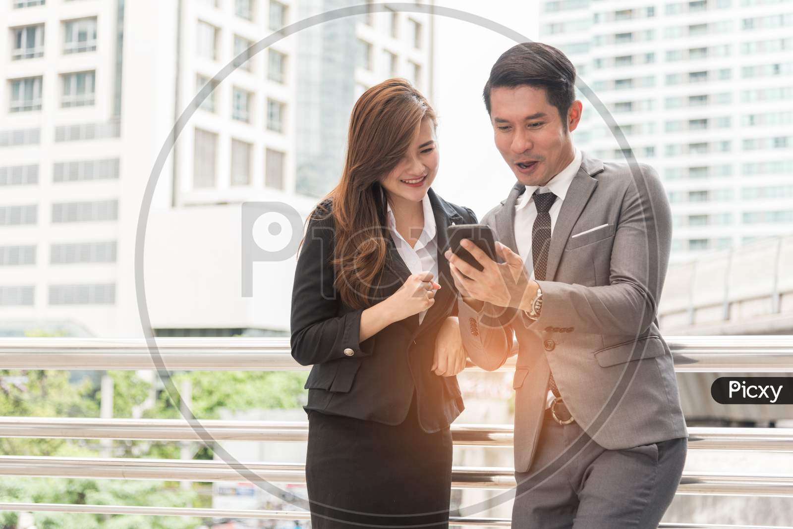 Two Businessman And Woman Enjoy Using Mobile Phone. Relax Time And Happiness Concept.