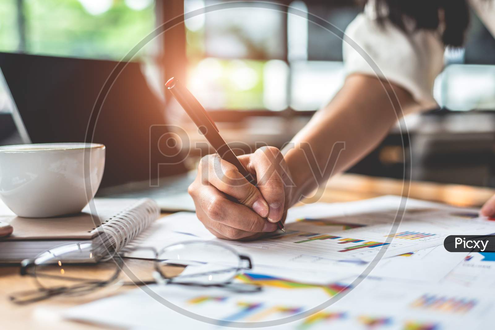 Close Up Of Businesswoman Hand Writing Summary Report Data. Marketing And Business Ownership Concept. People And Lifestyles Concept. Business Employee And Financial Theme