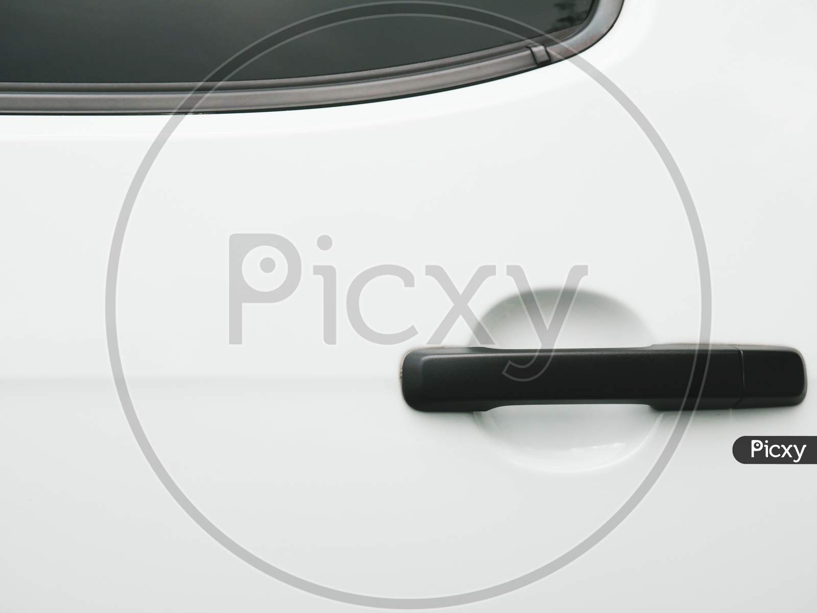 Black Car Door Handle On White Background. Automobile And Texture Concept. Automotive Industry And Safety Lock And Remote Key Accessories Concept. Vehicle Part Unlock Theme