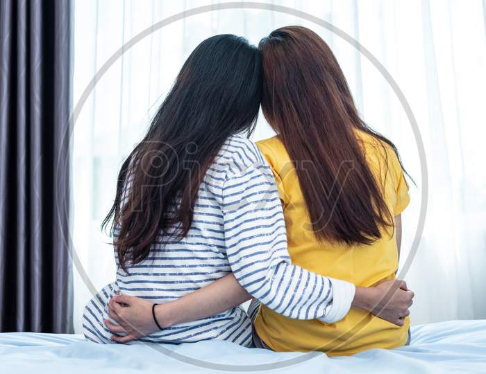 Back View Of Asian Beauty Embracing Together By A Girl Friend. People And Lifestyle Concept. Relationship And Friendship Theme. Lesbian And Lgbt Pride Theme.