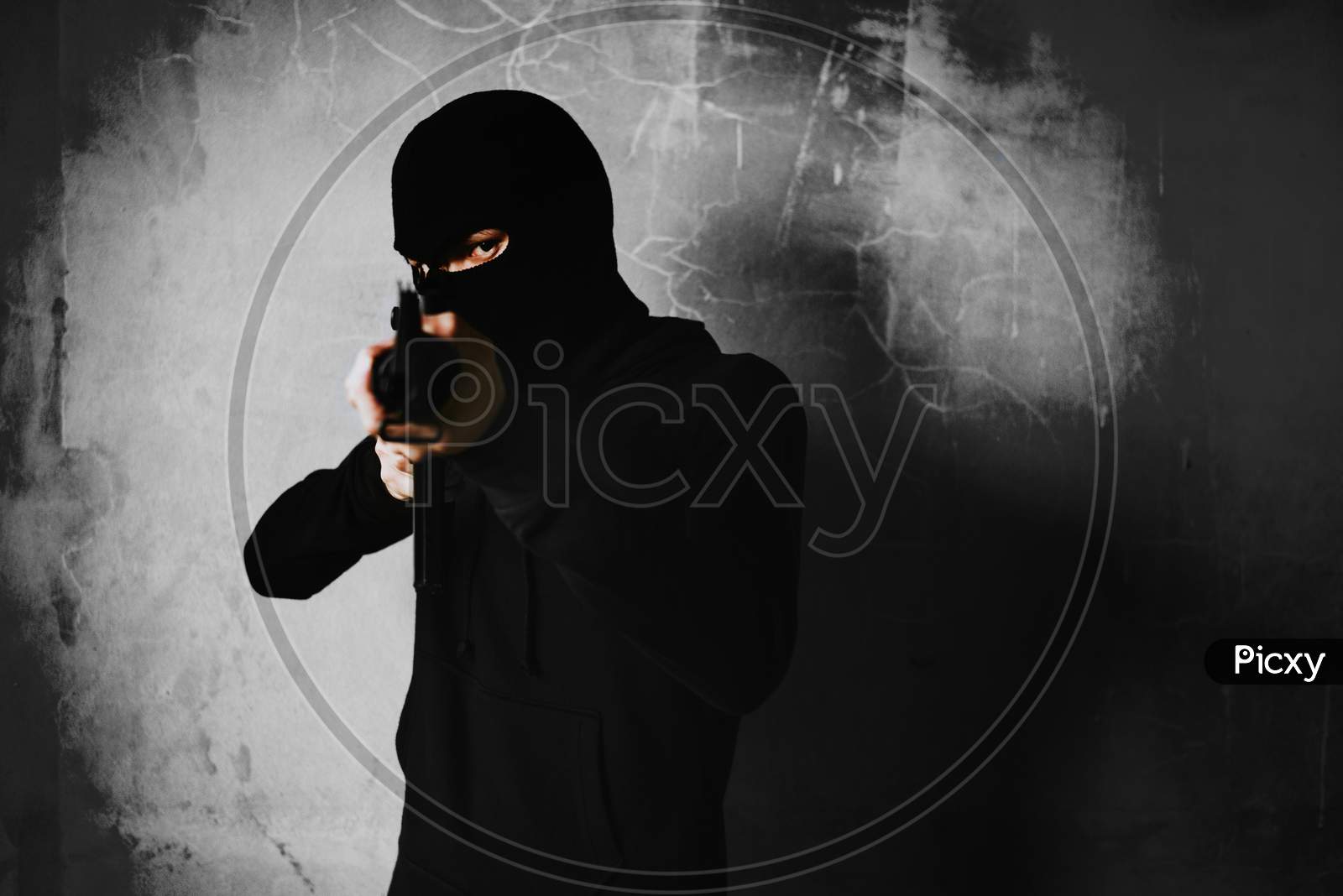 Terrorist Shooting With His War Gun Weapon With Grunge Room Wall Background. Criminal And Dangerous Illegal People Concept. Terrorist And War Theme. Dark Tone And High Contrast Use