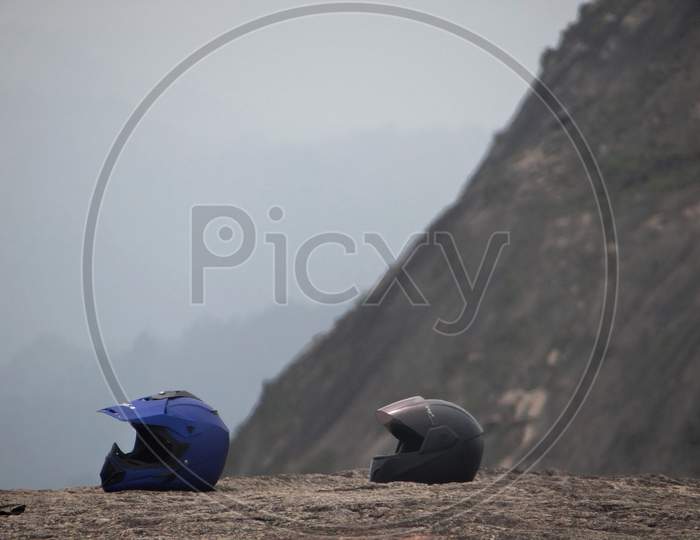 Two Helmets Placed Amidst The View Of The Hills At Idukki, Kerala, India
