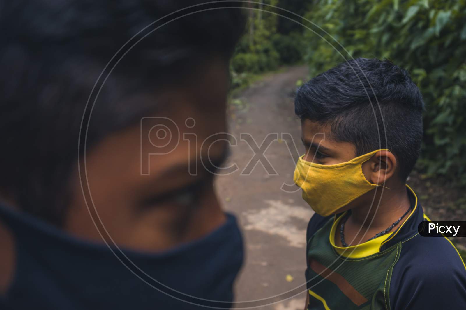 portrait of two boys wearing mask.