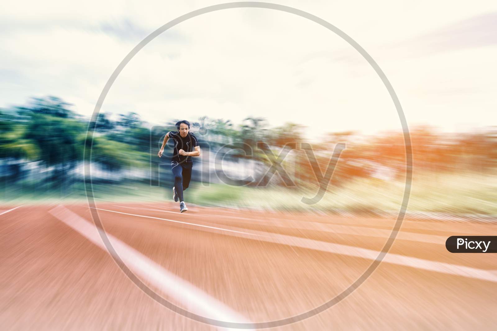 Running Man Running On The Track With Radial Blur, Sport And Activity Concept