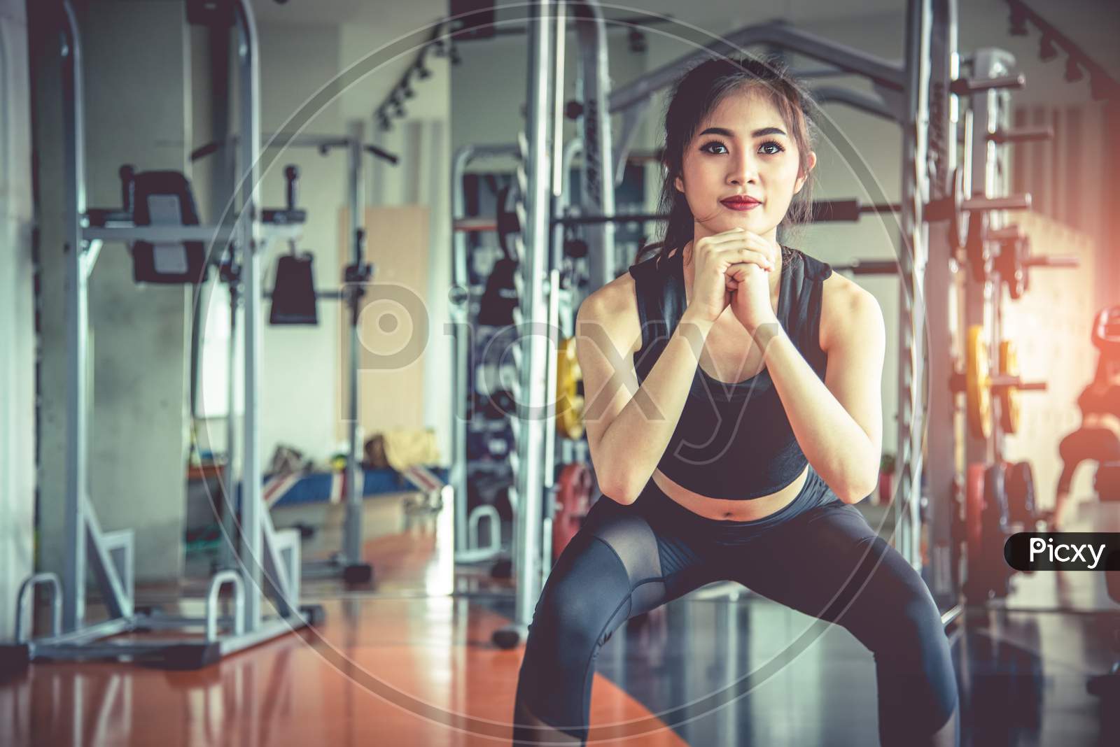 Young Asian woman working on pilates ladder barrel machine during