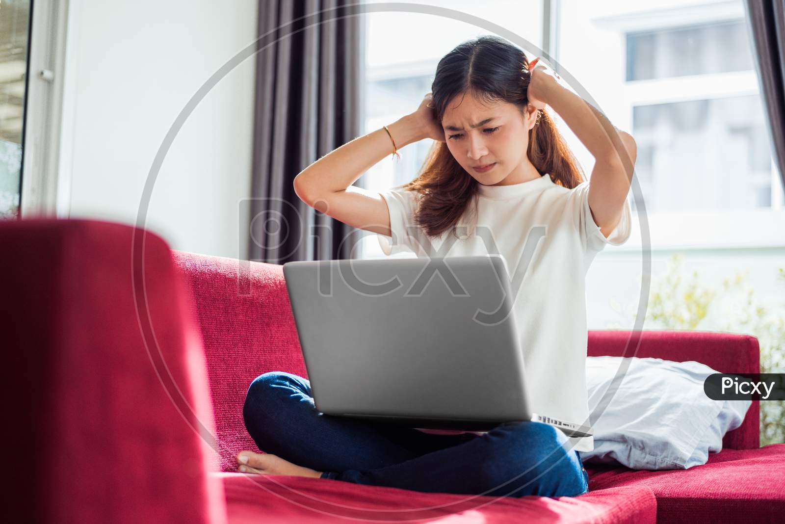 Asian Young Exhausted Businesswoman Having Headache While Using Laptop On  Sofa In Her House. Business People Worry And Stress About Job Deadline Concept. Online Shopping Marketing Technical Problem
