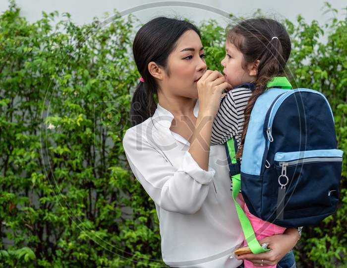 Mom Feeding Her Daughter With Snack Before Going To School. Back To School And Education Concept. Home Sweet Home And Happy Family Theme.