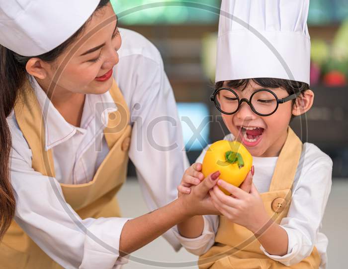 Portrait Cute Little Asian Happy Boy Chef Interested In Cooking With Mother Funny In Home Kitchen. People Lifestyles And Family. Homemade Food And Ingredient Concept. Vegetable Salad Making