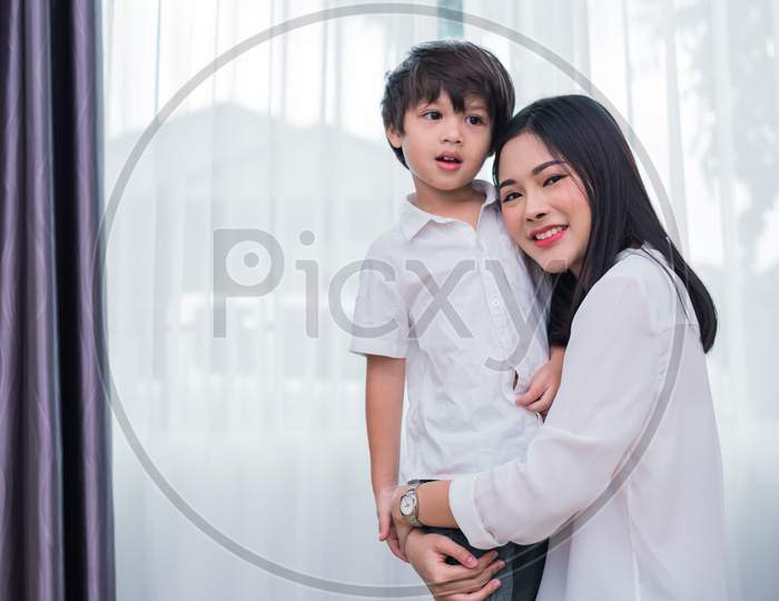 Beauty Asian Woman Hug And Carry Her Son. Happy Family And Home Sweet Home Concept. Love And Lifestyle Theme.