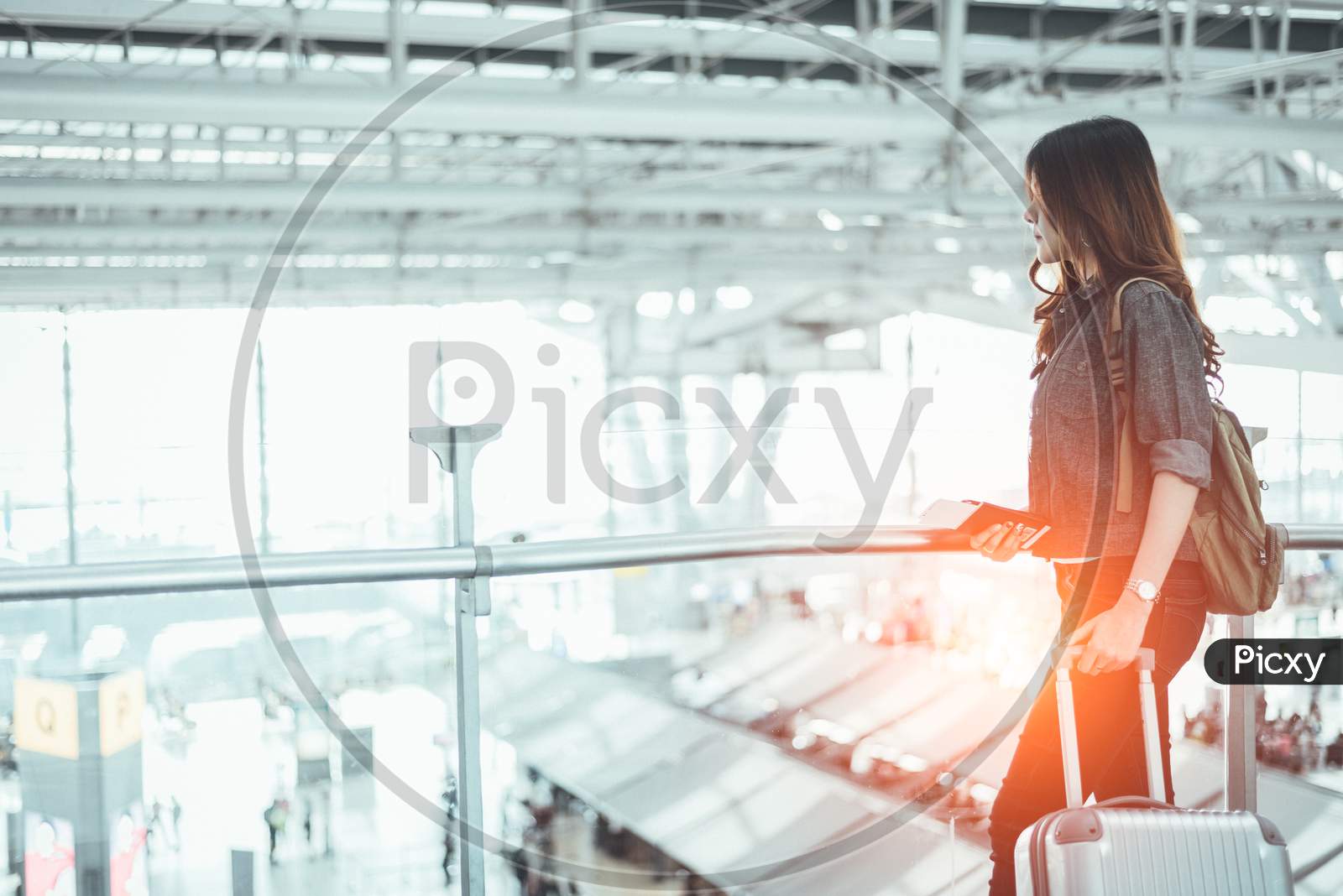 Beauty Woman Waiting For Take Off Flight In Airport. Asian Woman With Trolley Suitcase. People And Lifestyles Concept. Transportation And Travel Theme. Airplane And Train Theme.