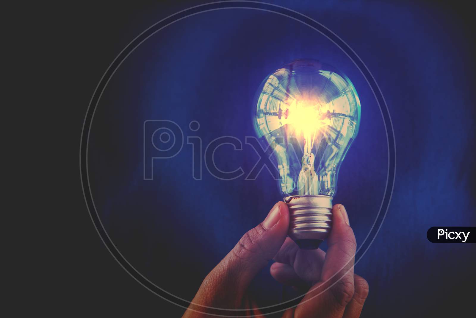 Bulb With Lighting. Idea And Creative Concept  For Startup New Project. Technology Object And Electrical Part Theme. Energy And Power Saving Theme. Copy Space In The Left Side. Blue Filter Background