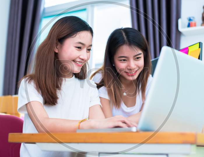 Two Young Freelancer Asian Girl Businesswomen Private Working At Home Office With Laptop Or Computer With Notebook On Desk. Packaging Delivery Online Shopping And Marketing Service To Customer