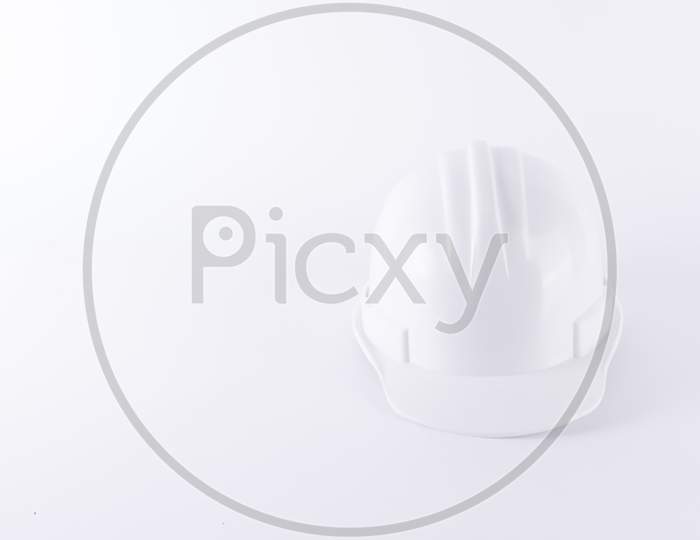 White Safety Helmet On White Background. Hard Hat And Thick Gloves On White Isolated Background. Safety Equipment Concept. Worker And Industrial Theme.