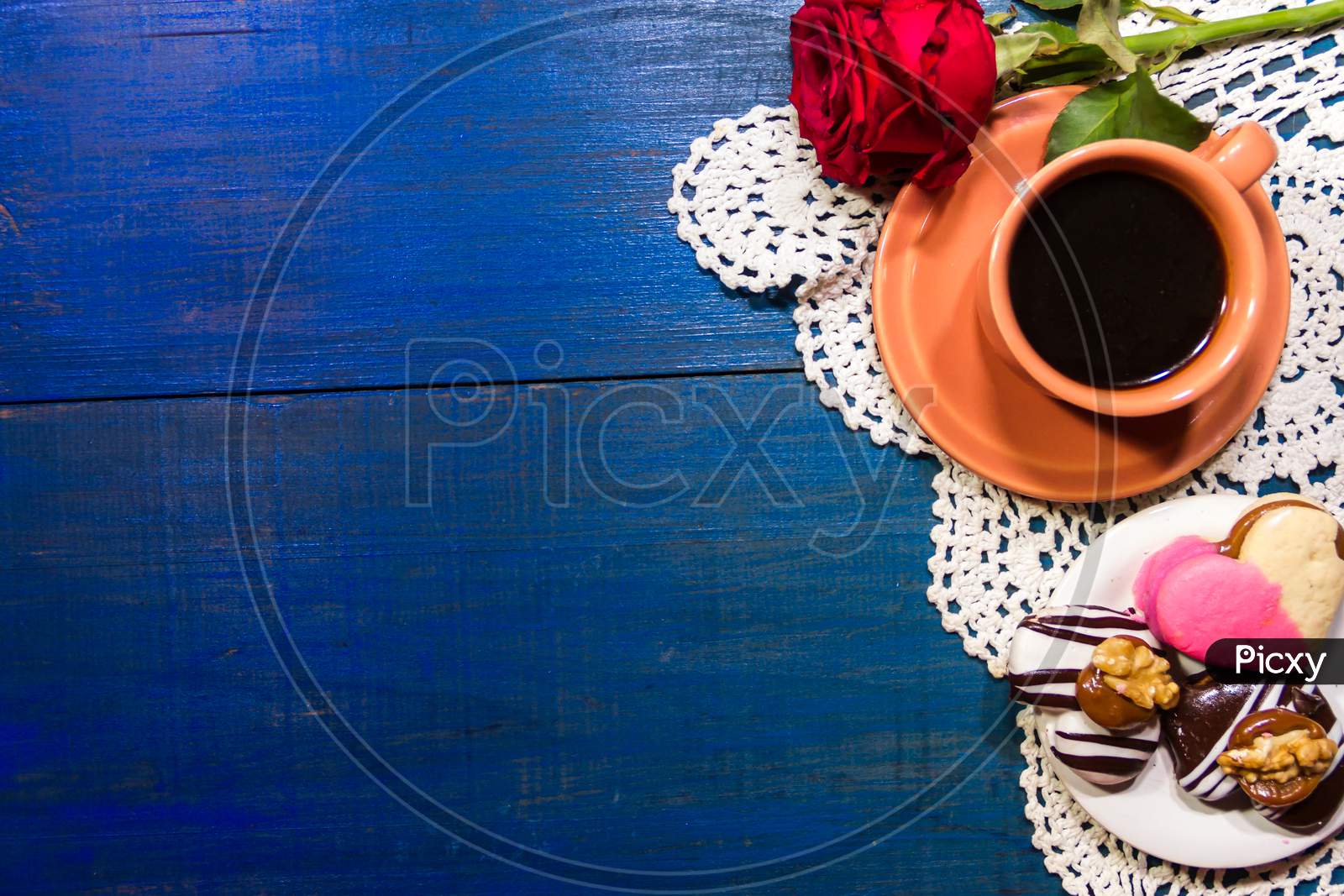 Romantic Flowers With Coffee And Sweet Treats On The Table