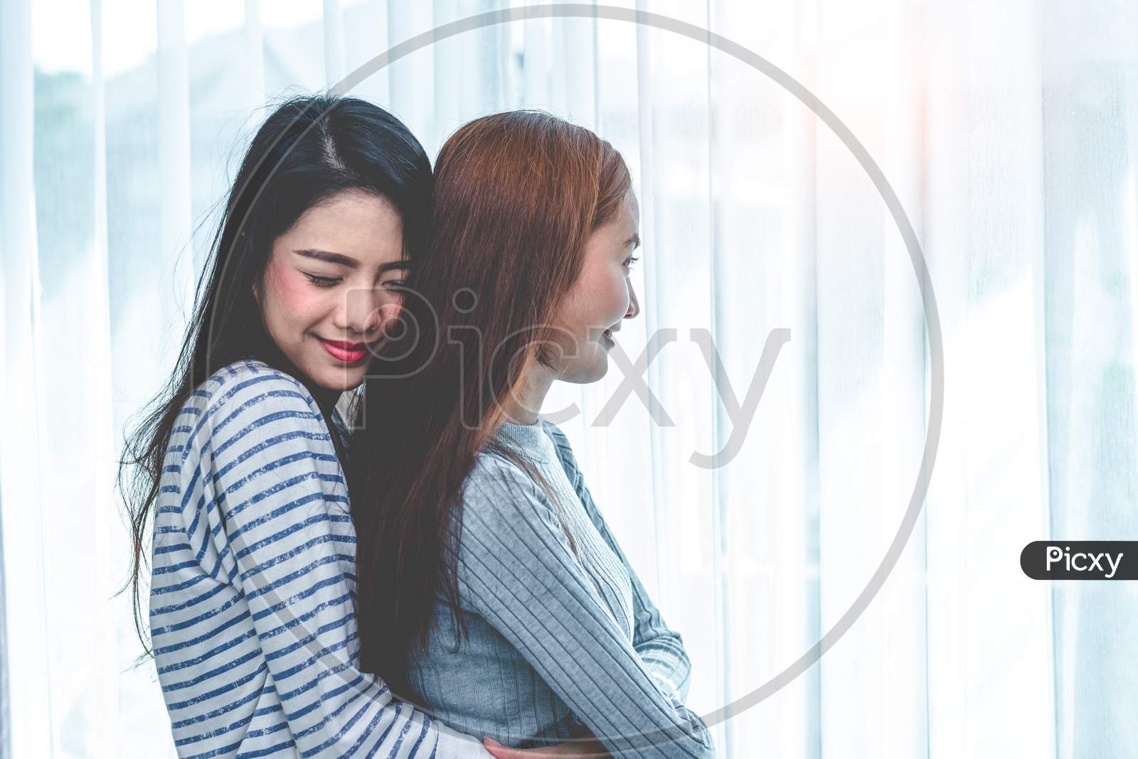 Image Of Two Asian Lesbian Women Hug And Embracing Together In Bedroom