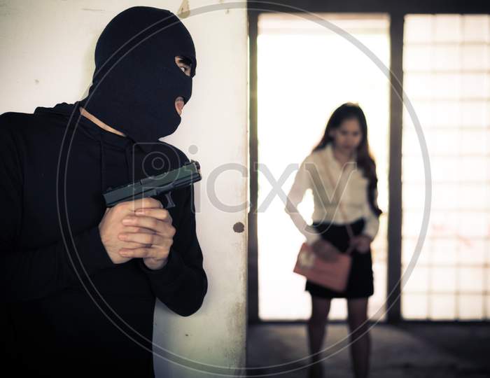 Robber Holding Up And Waiting Woman To Steal Her Wallet Or Hand Bag By Hand Gun In Corner Of Building. Criminal Sexual And Dangerous Illegal Violence Crisis Concept