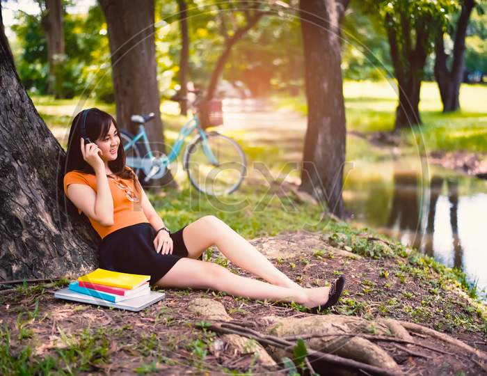 Woman Relax Under The Tree In The Park With Headphones, Relax Concept