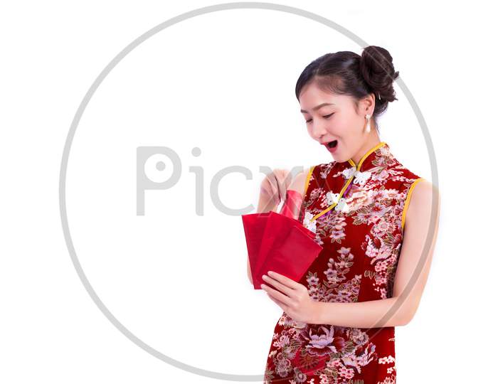 Young Asian Beauty Woman Wearing Cheongsam And Holding Packet Of Moneys And Surprising Gesture In Chinese New Year Festival Event On Isolated White Background. Qipao Dress Wearing. Lifestyle Concept