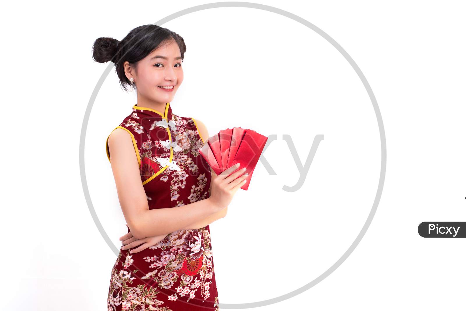Young Asian Beauty Woman Wearing Cheongsam And Holding Packet Of Moneys Gesture In Chinese New Year Festival Event On Isolated White Background. Holiday And Lifestyle Concept. Qipao Dress Wearing